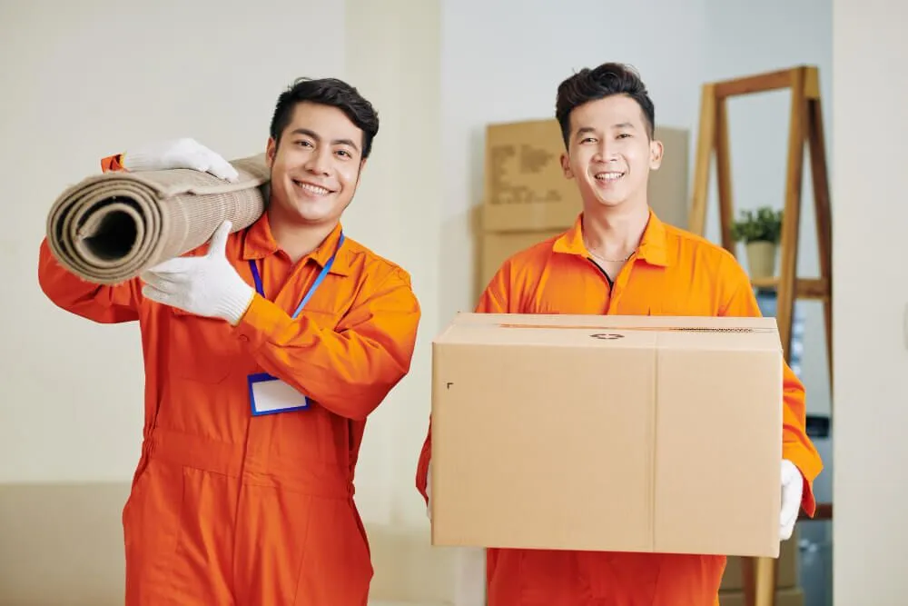 movers-carrying-carpet-cardboard-box-1